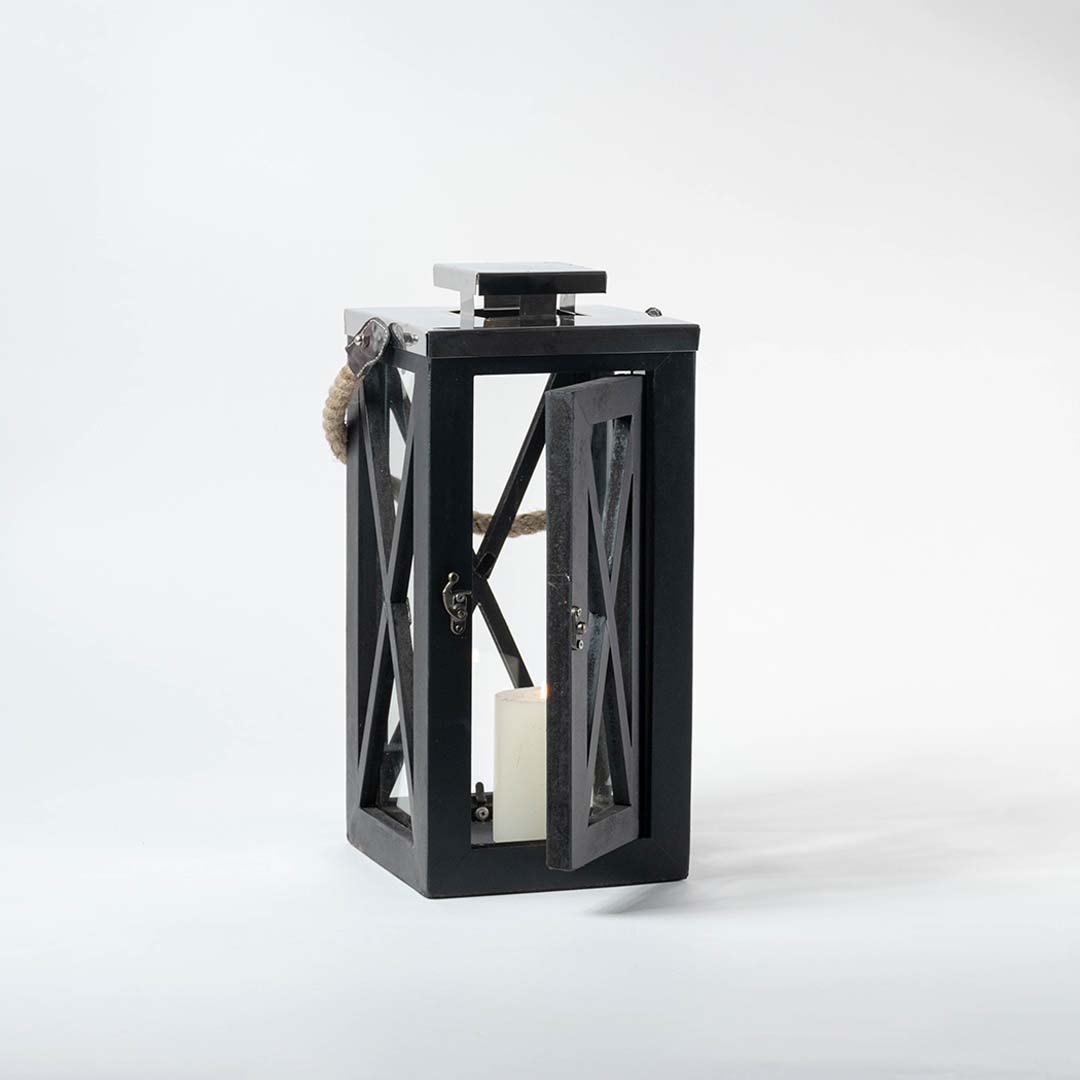 Black wooden lantern with clear glass panels and rope handle for farmhouse tabletop decor styling.