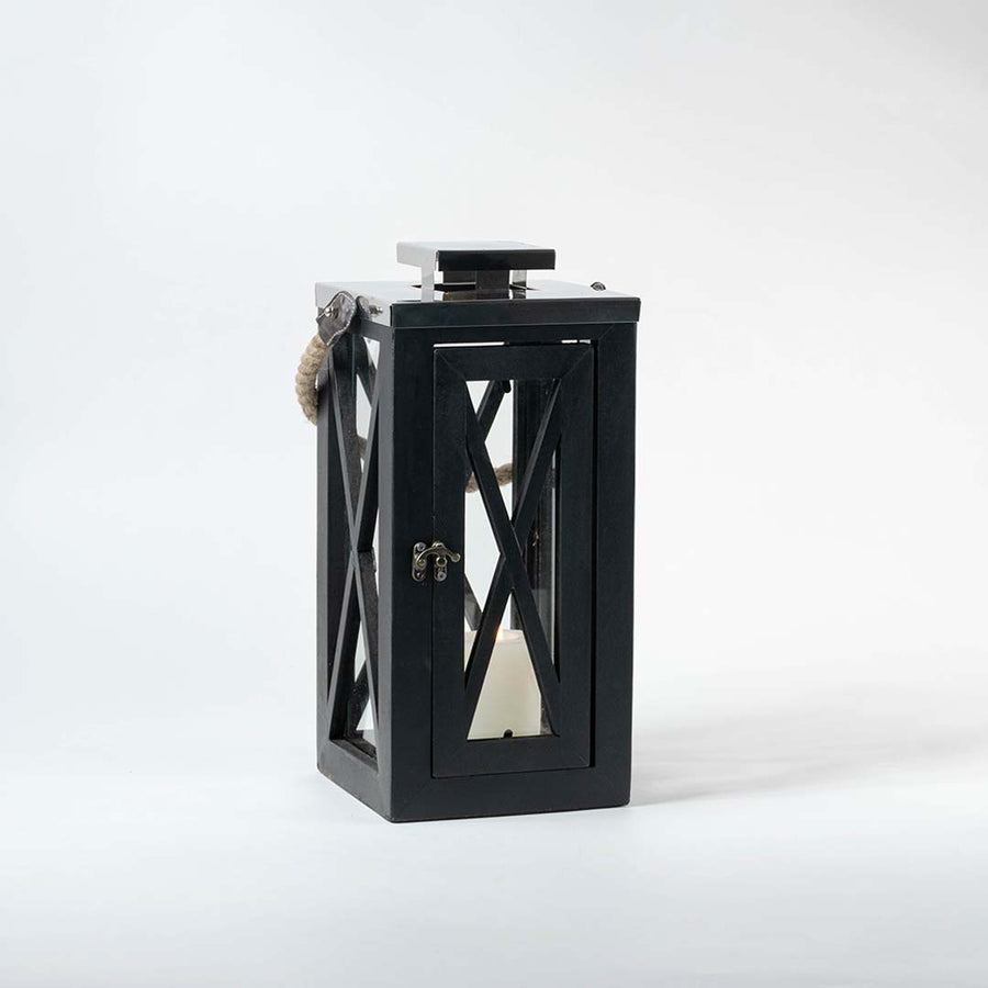 Modern black metal decorative lantern with cutout design shown on white background for table shelf and patio decor use.