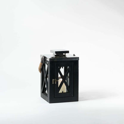 Black metal lantern with glass panels and candle holder displayed on white background ideal for indoor and outdoor decor styling.