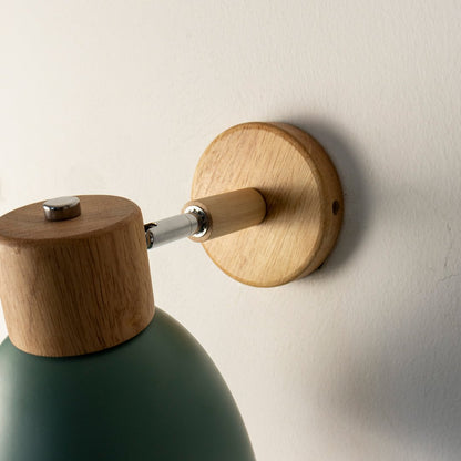 Closeup of green metal and wooden wall light for modern bedroom hallway and minimal decor styling spaces.