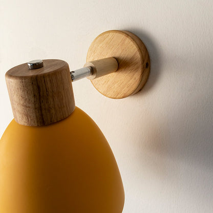 Contemporary mustard yellow wall light with wooden accents for elegant modern interior styling.