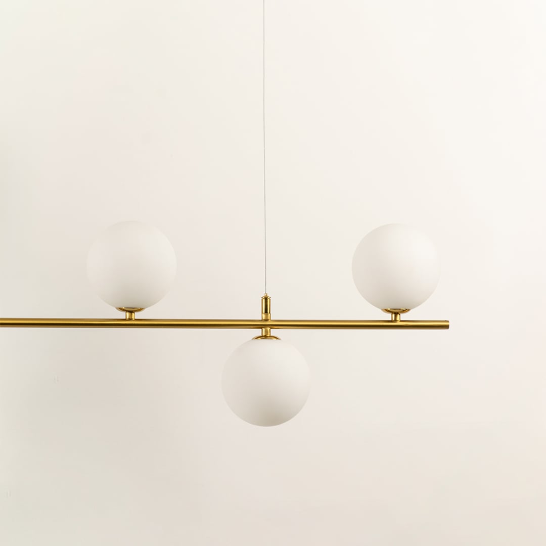 Frosted glass globe chandelier with gold metal frame showcasing refined craftsmanship and contemporary decorative lighting.
