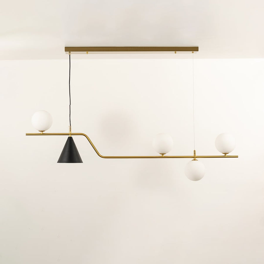 Gold metal chandelier with frosted glass globe shades designed for stylish modern dining room ceiling lighting.