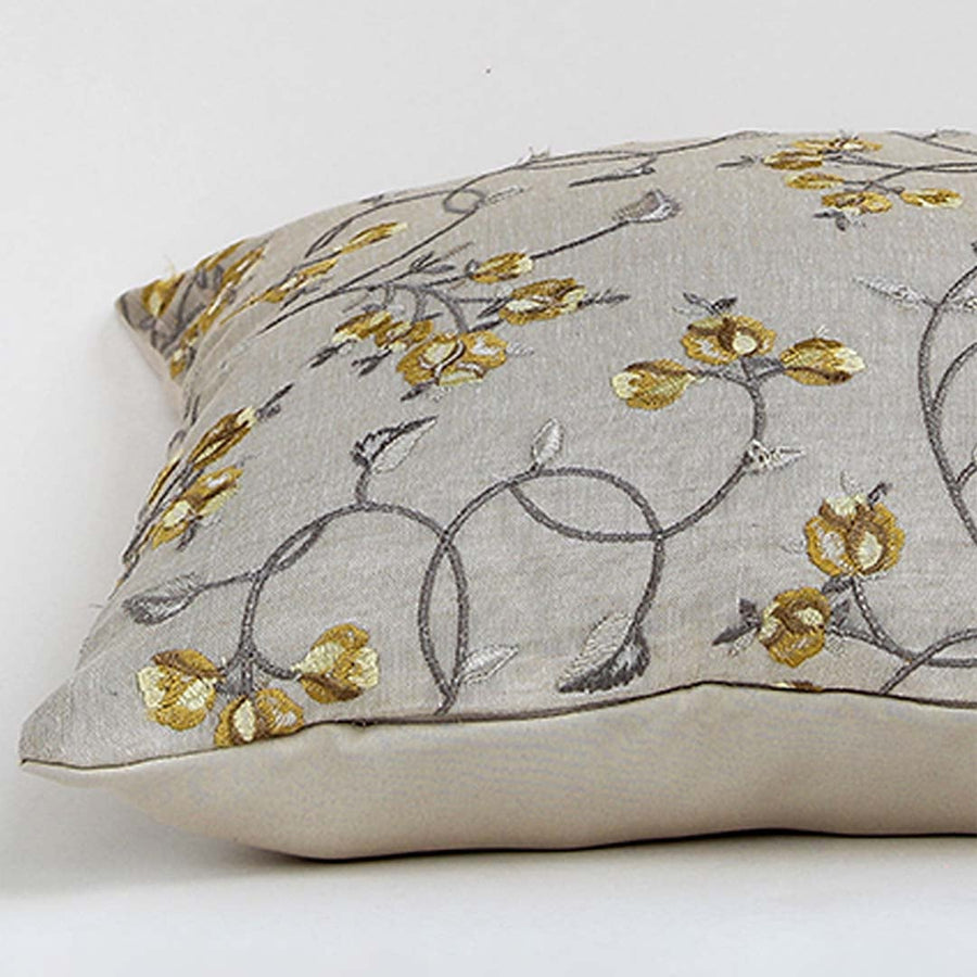 Light beige cotton cushion cover with grey and yellow floral embroidery ideal for modern home décor while providing a soft comfortable and skin friendly fabric experience.
