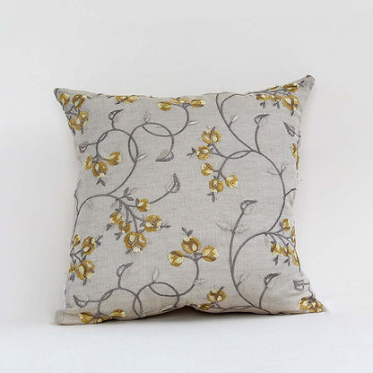 White cotton cushion cover with delicate mustard floral print for sofa couch bedroom and elegant home decor styling.