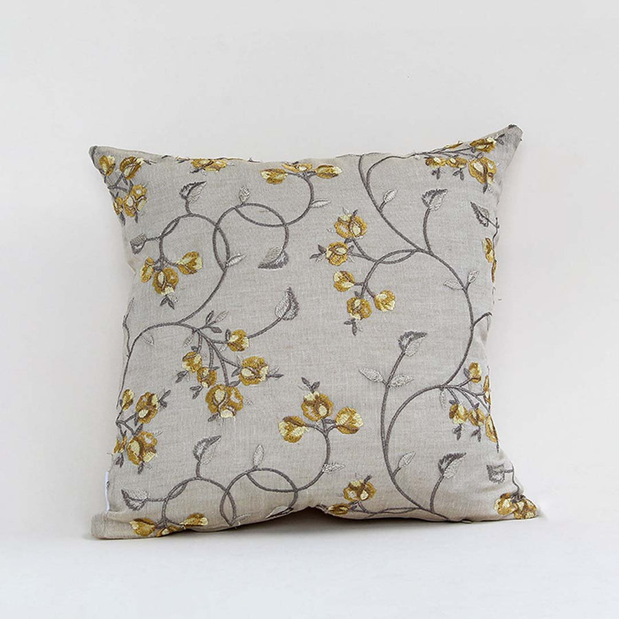 White cotton cushion cover with delicate mustard floral print for sofa couch bedroom and elegant home decor styling.