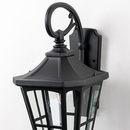 Closeup of lantern gate light showing detailed metal frame and clear glass design.