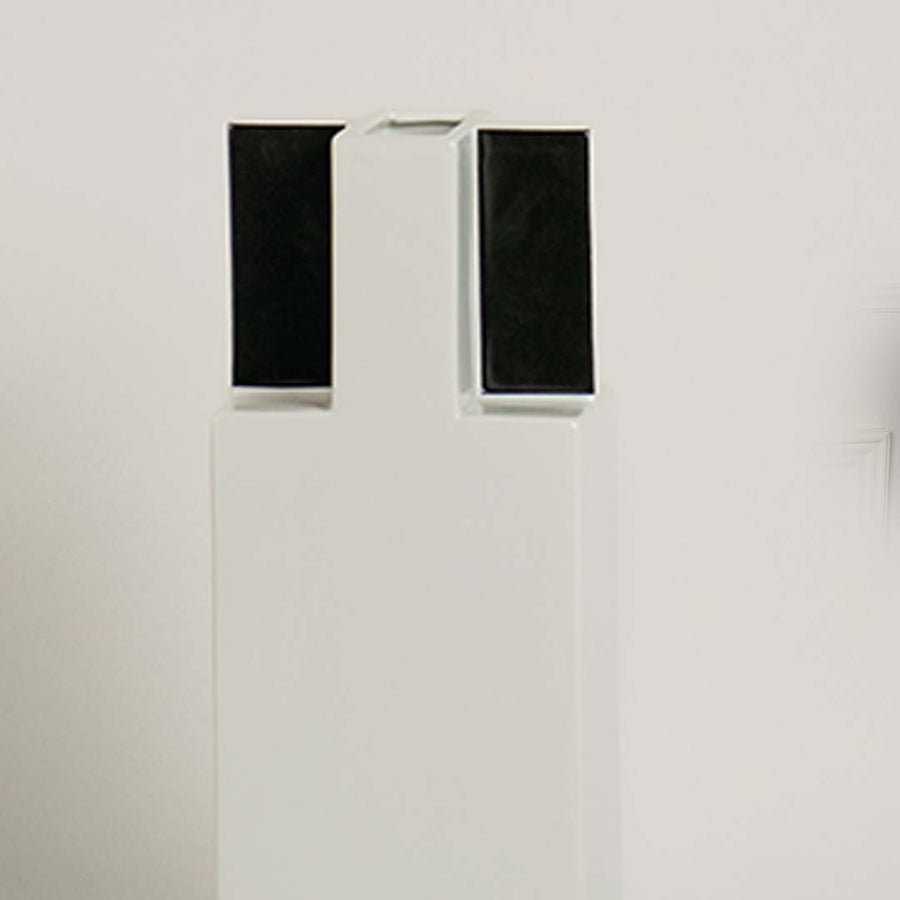 Closeup of ceramic vase in white with black square top showing modern minimal design perfect for home decor accent.
