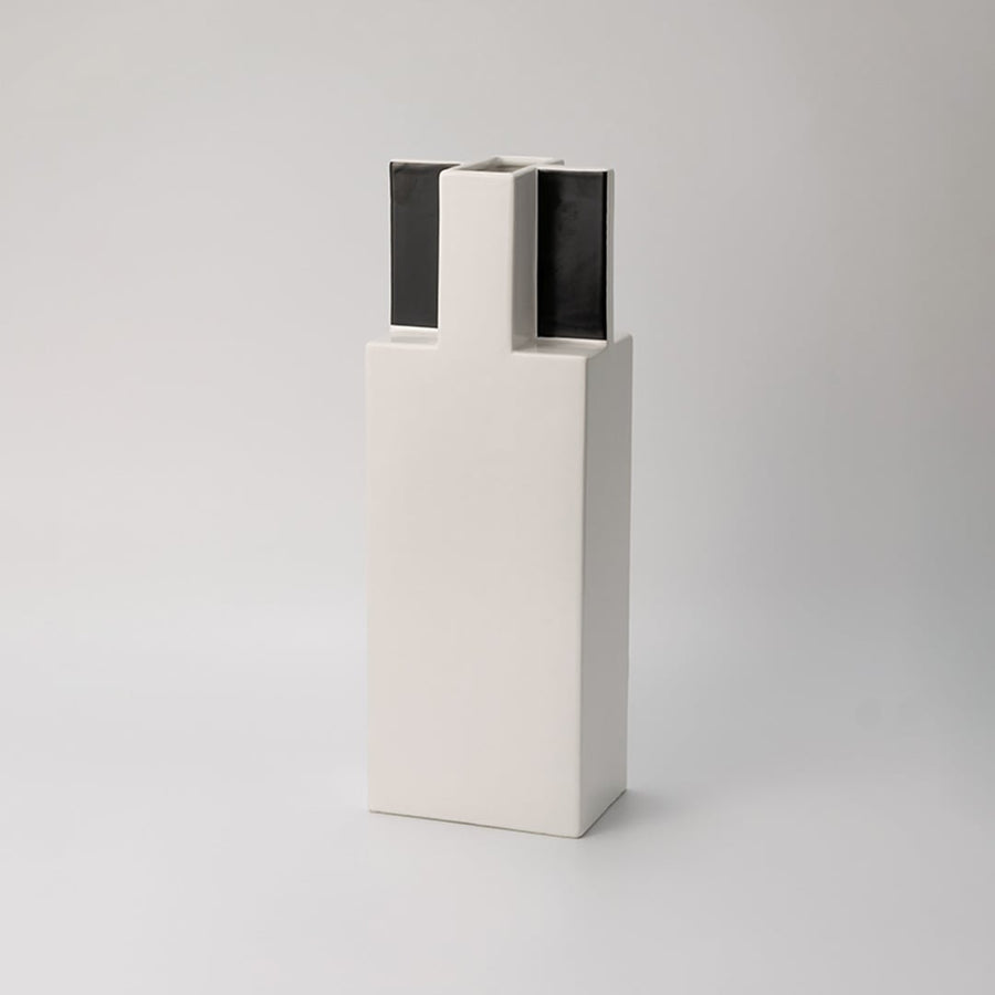 White ceramic vase with black top minimal rectangular design displayed on white background for modern home styling.