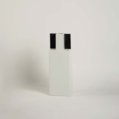 Minimal rectangular ceramic vase in white with black detail displayed on clean white background decorative accent.