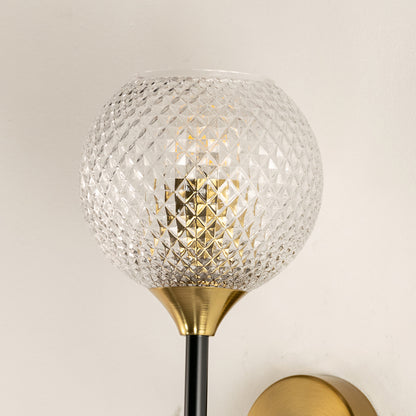 Modern gold metal wall light with textured glass globe shade for stylish bedroom hallway and living room decor.