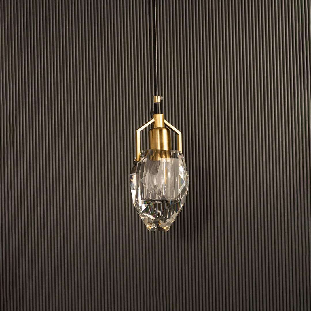 Crystal pendant light with metal accents shown switched off against a dark background presenting a refined luxurious silhouette for contemporary interior decor.