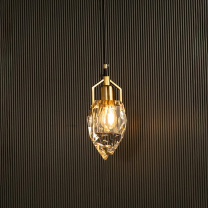 Crystal pendant light with metal detailing casting radiant highlights imagined against a dark background creating a dramatic elegant interior decor mood.