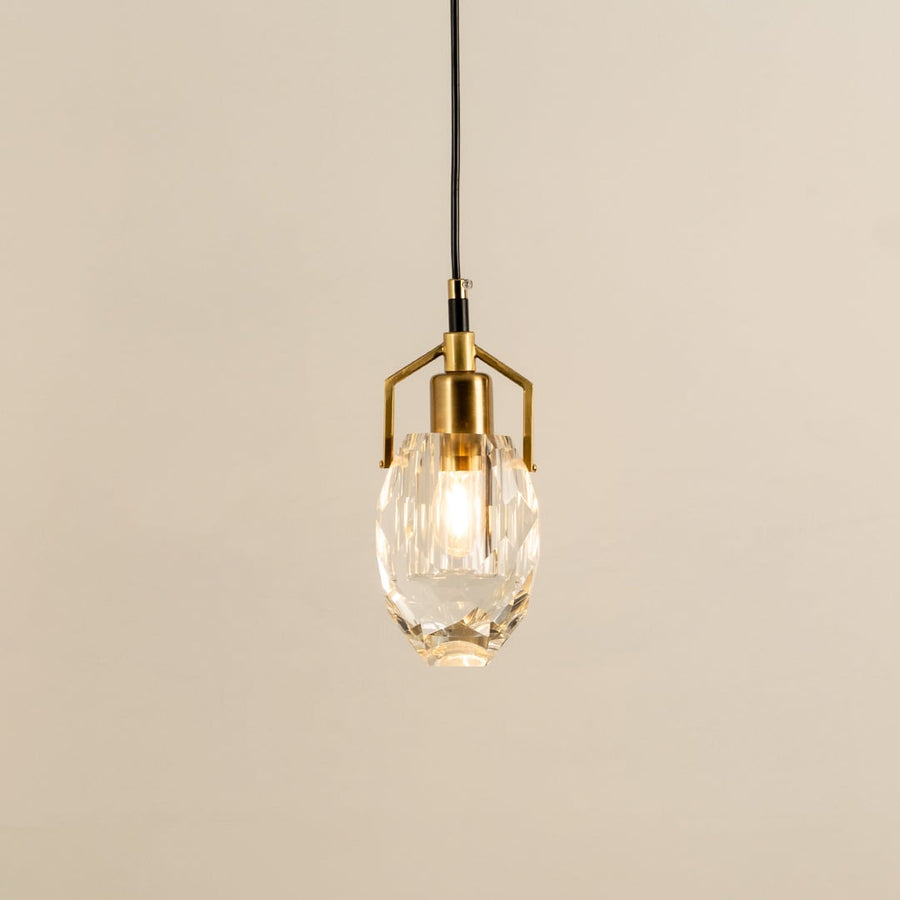 Crystal pendant light with polished metal accents glowing beautifully against a clean white background showcasing refined minimalist interior home decor lighting style.