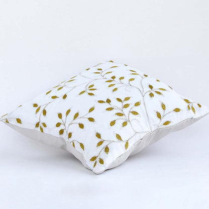 Soft cotton cushion cover with golden botanical embroidery shown at an angle offering a warm nature inspired décor accent with a breathable gentle and skin friendly fabric finish.