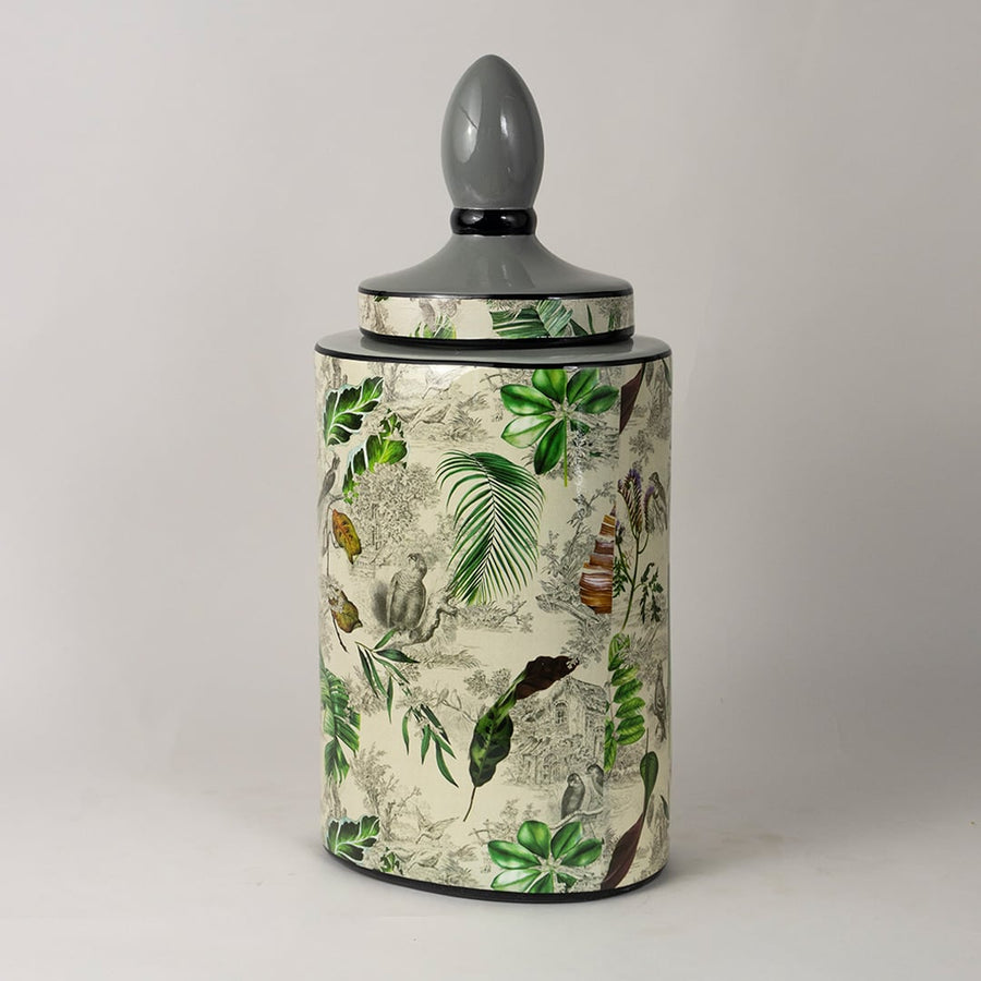 Side angle view of tropical leaf jar revealing curved surface and hand painted leaf detailing.