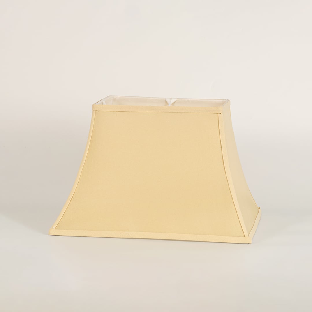 Cream bell shaped lamp shade shown in close up view on plain background for classic elegant lighting décor.