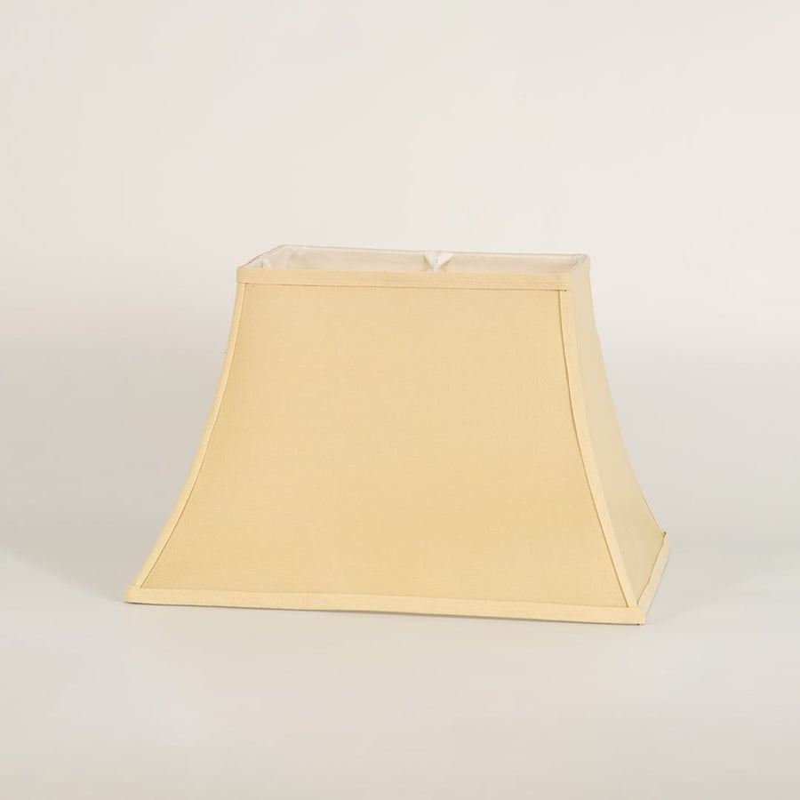 Cream bell shaped lamp shade shown in close up view on plain background for classic elegant lighting décor.