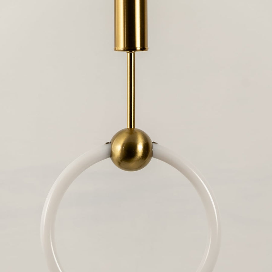 Closeup view of pendant light highlighting its white ring shade smooth metal accents and minimalist structure showcasing refined craftsmanship for interior home decor.