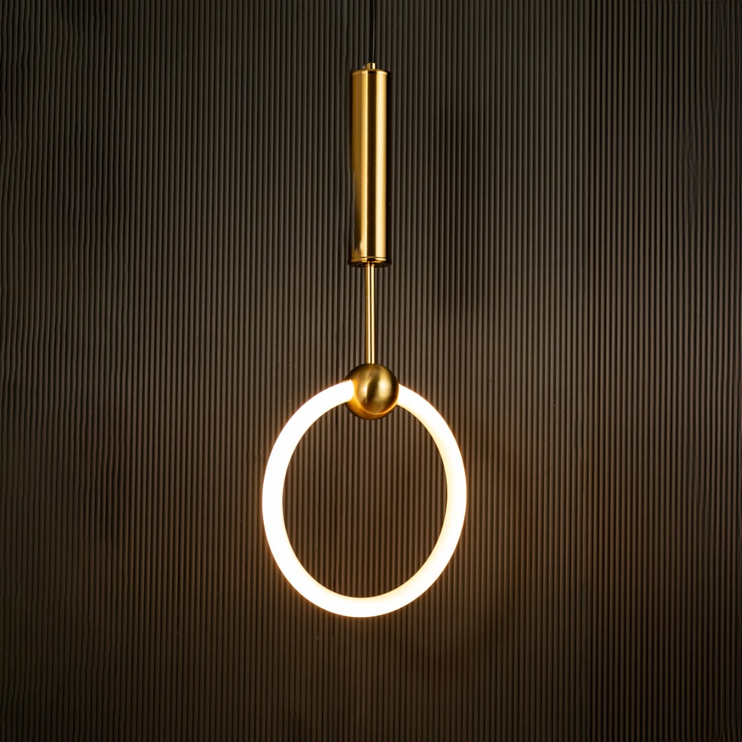White ring pendant light with sleek metal cylinder casting warm ambient glow imagined against a dark black background creating a dramatic modern interior decor mood.