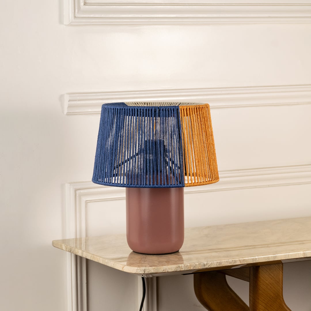 Table lamp with woven blue and orange shade shown switched off on a clean white background highlighting its artistic modern form suited for interior decor settings.