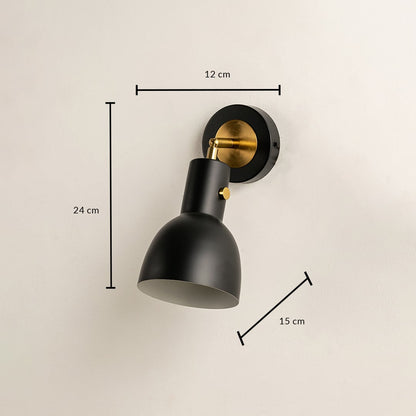 A black metal wall light measuring 24 cm height 15 cm depth and 12 cm width displayed against a beige wall highlighting its compact geometric form for refined contemporary décor.