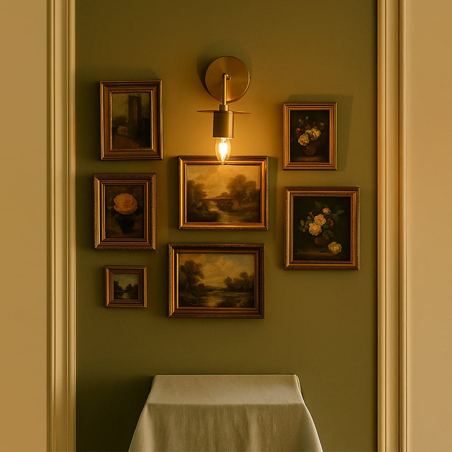 Gold wall sconce with round metal shade lighting up a cozy living room adding luxury and warmth to home interiors.