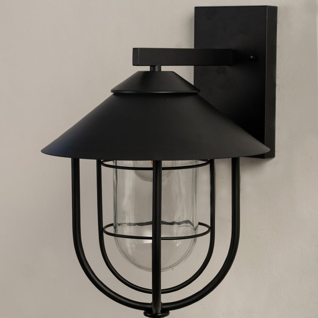 Close view of the black outdoor lantern highlighting its rounded metal frame clear glass enclosure and refined detailing.