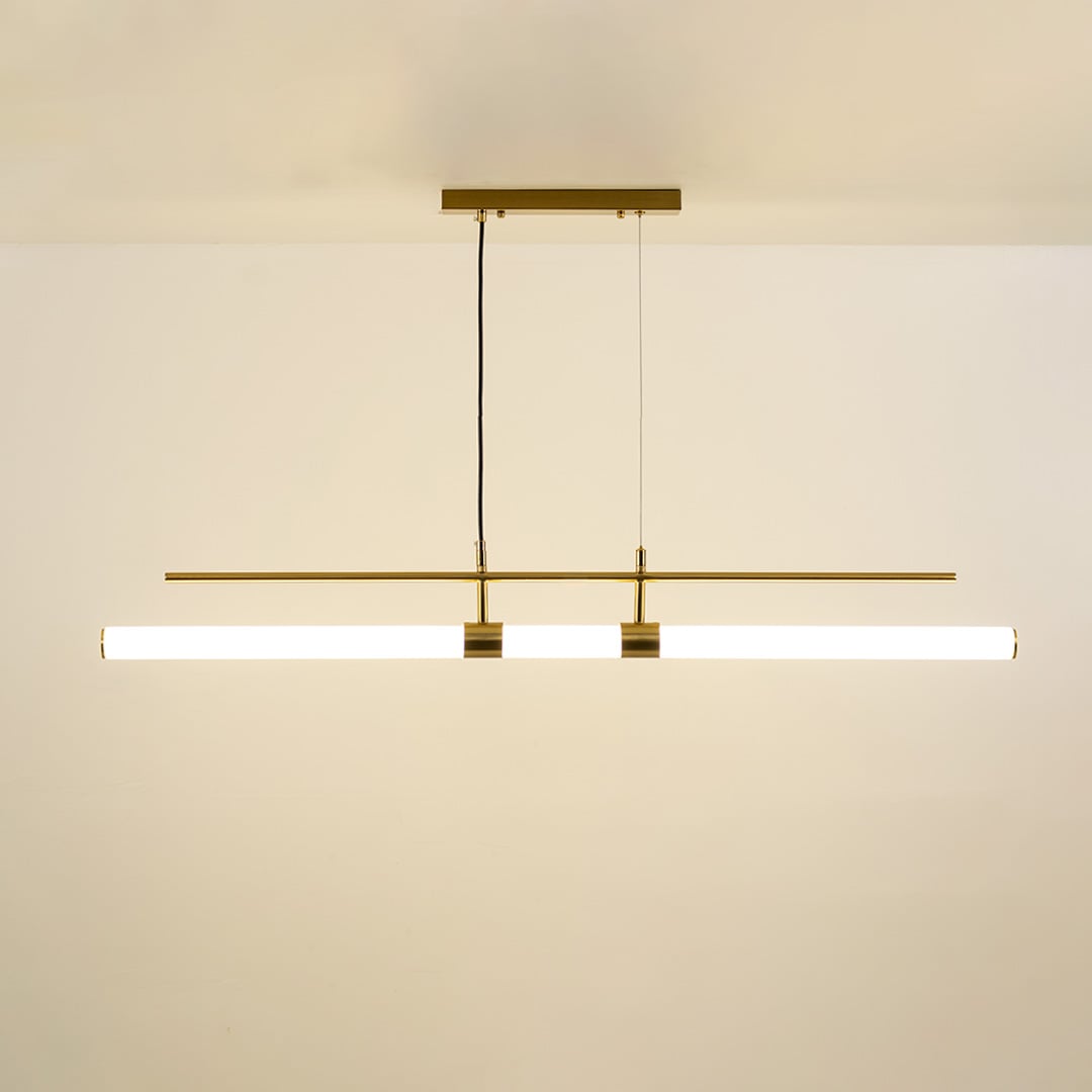 Gold metal linear pendant light with integrated LED bars creating sleek modern ambient lighting for dining spaces.