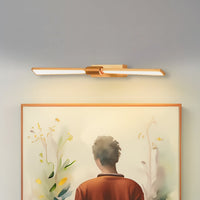 Gold metal picture light illuminating artwork with warm focused lighting creating elegant gallery inspired wall decor.