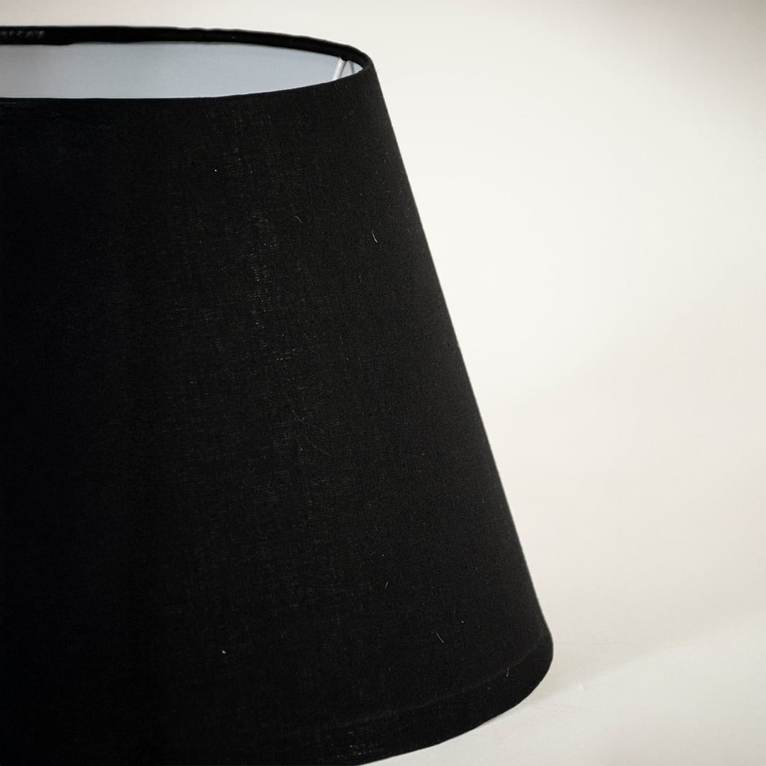 Detailed view of smooth black fabric texture and tapered shape of lamp shade highlighting premium material craftsmanship quality.