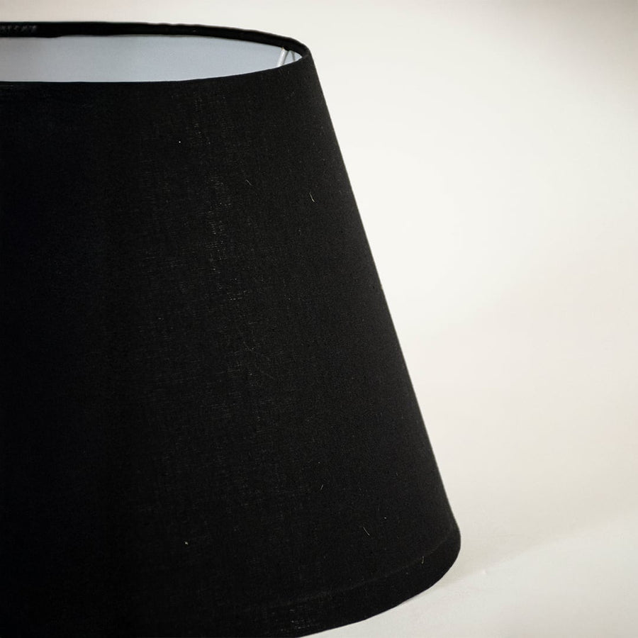 Detailed view of smooth black fabric texture and tapered shape of lamp shade highlighting premium material craftsmanship quality.