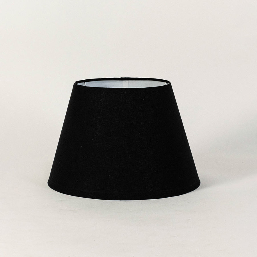 Black fabric lampshade with tapered silhouette and textured finish designed for table lamps and modern interiors.