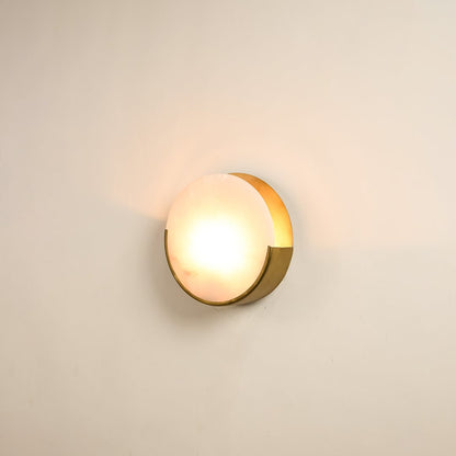 Elegant marble wall sconce with golden base illuminated on white background showcasing timeless beauty perfect for modern and classic decor.