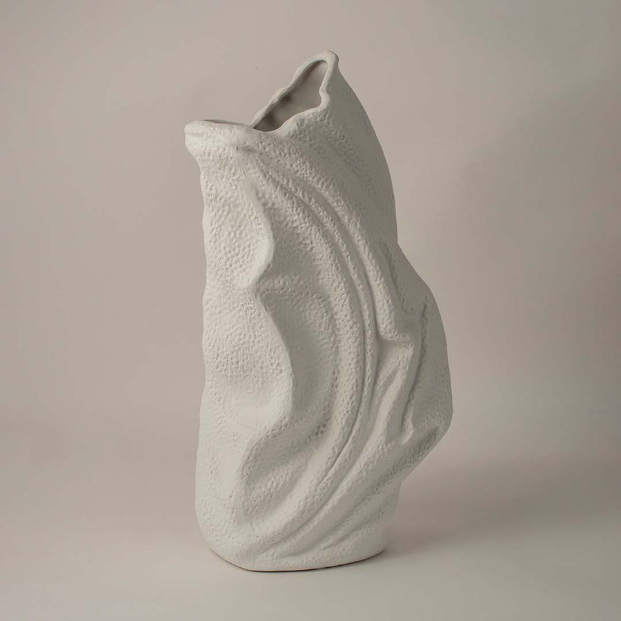 Side angle view of white ceramic decorative vase with sculptural wave texture ideal for living room or hallway decor.