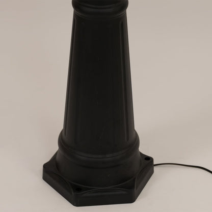 Detailed close up of black metal post lamp base showing textured pole construction decorative rings and mounting foundation design.
