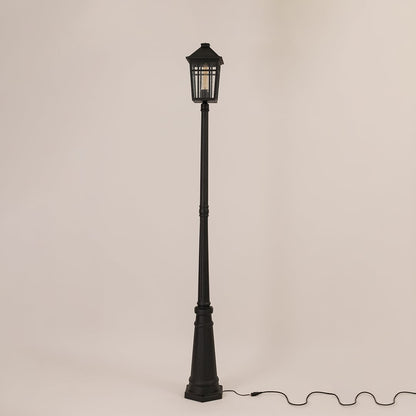 Tall outdoor post lamp in black metal shown unlit on off white background designed for pathway driveway and garden lighting.
