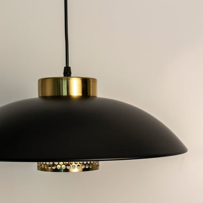 Black and gold pendant light featuring a sleek dome-shaped matte black shade and golden accent ring with light off.