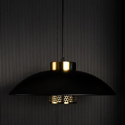 Designer pendant light with black metal shade and gold detailing shown unlit on black background for premium interior lighting design.