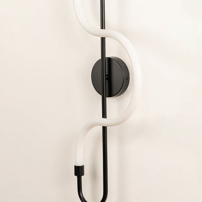 Minimal wall light closeup with white rod and black mount detail showing modern design and finish for indoor decor styling.