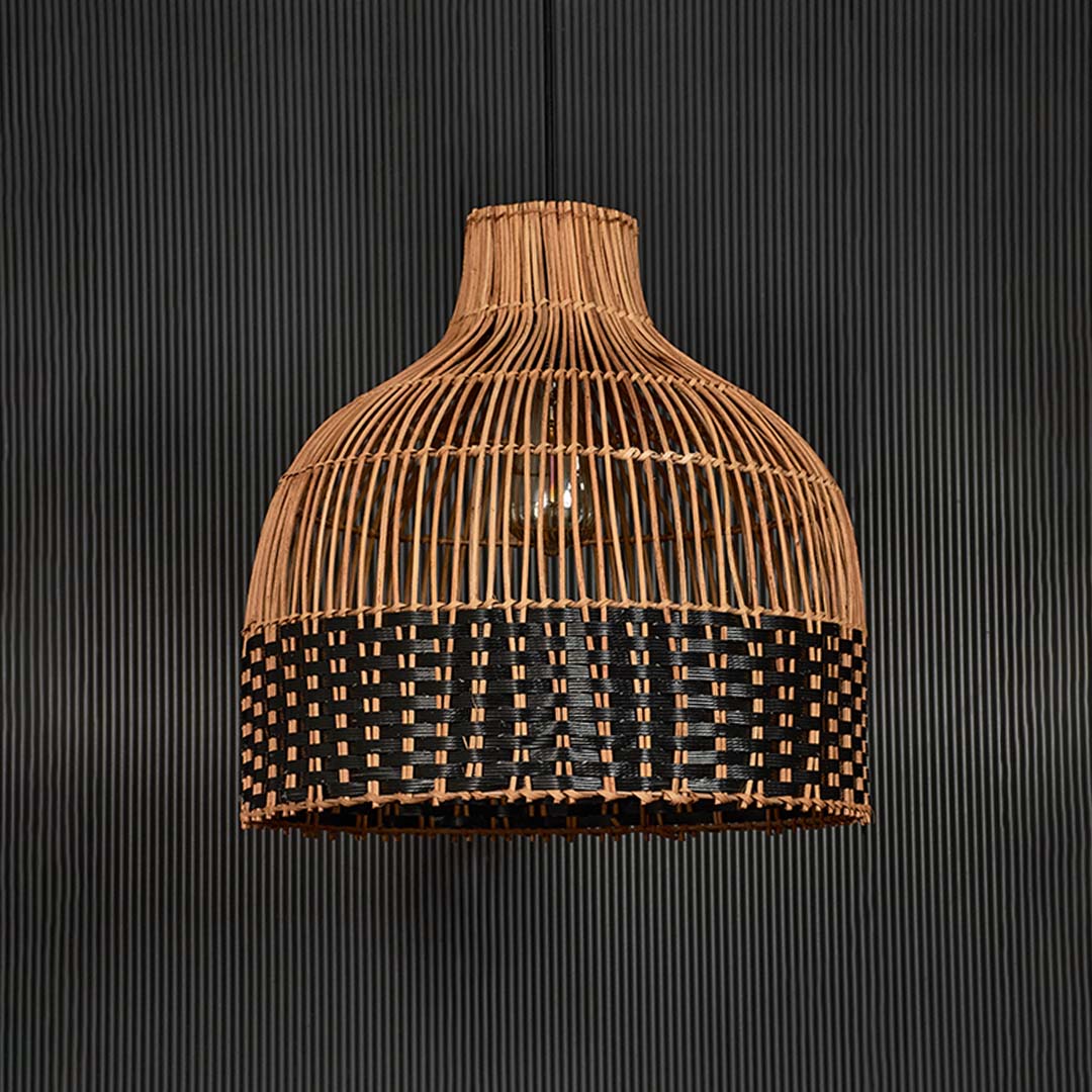 Two-tone rattan pendant light on black background highlighting intricate craftsmanship and balanced woven texture.