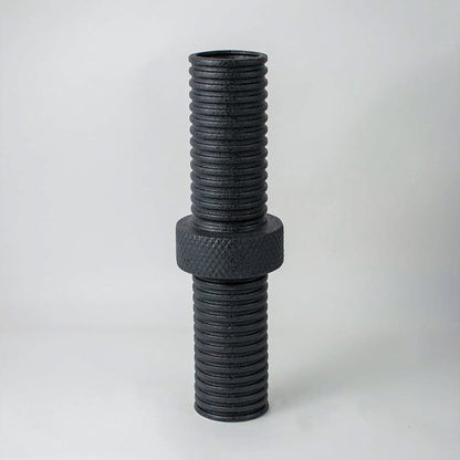 Modern matte black ridged cylindrical vase for minimalist home interiors and stylish contemporary table decor accents.