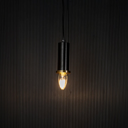 Black and gold pendant lamp on black background is an elegant cylindrical ceiling light for modern spaces.