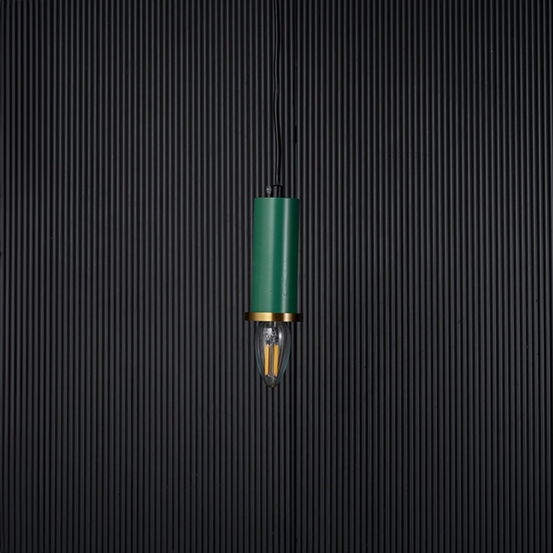 Green pendant light turned off with brass ring and clear bulb shown as elegant ceiling decor on black background.
