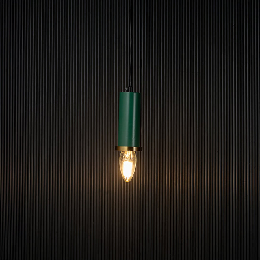Stylish green pendant light turned on with warm glowing bulb creating ambient lighting effect on black background.