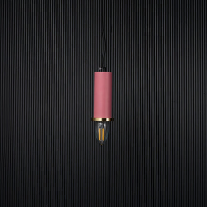 Pink pendant light turned off with brass accent and bulb shown as modern hanging decor on black background.