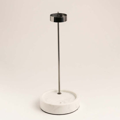 White metal table lamp with slim stem and circular base for modern bedside styling and ambient lighting.