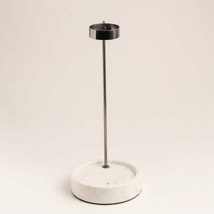 White metal table lamp with slim stem and circular base for modern bedside styling and ambient lighting.