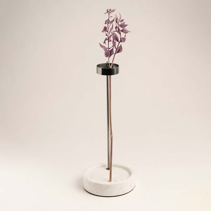 Metal stand vase on a clean white background emphasizing its black metal and marble base contrast.