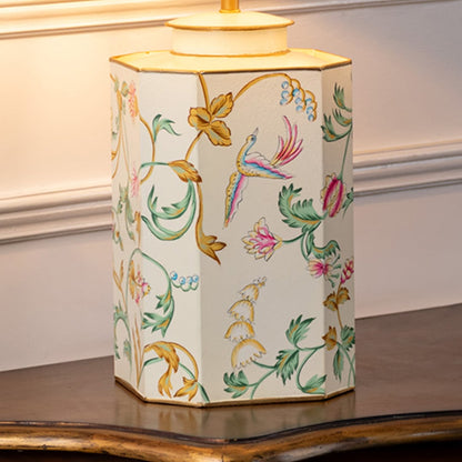 Table lamp closeup showing ceramic base with colorful floral and bird artwork finished with smooth glossy surface.